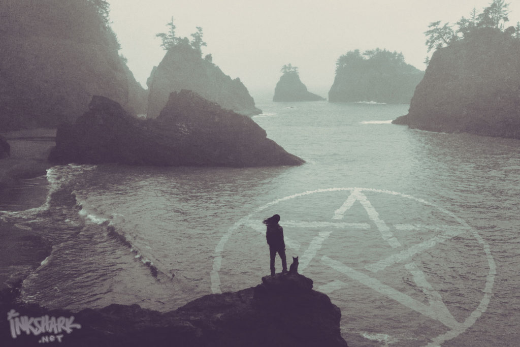 a low-saturation photograph of a foggy seashore with rocky islands blocking the view out to the ocean; in the foreground stands a feminine silhouette with long hair and by her feet a cat; superimposed over the water there is an enormous pentagram, like it is magically appearing in the waves
