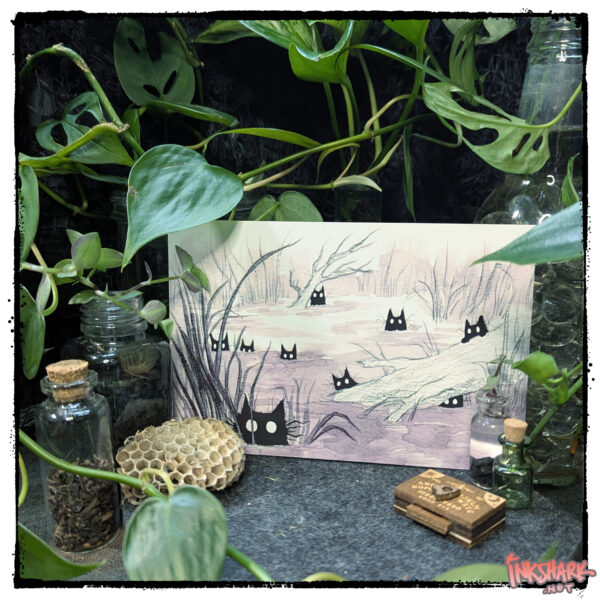 Postcard of a painting of spooky black cats in a swamp; product is posed among live plants with a dead wasp nest and the tiniest damn ouija board ever, for conjuring wee ghosts