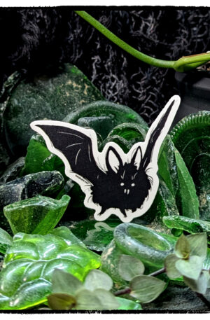 Sticker of a bat perched in a mass of adventurous green sea glass, with live plants guarding it
