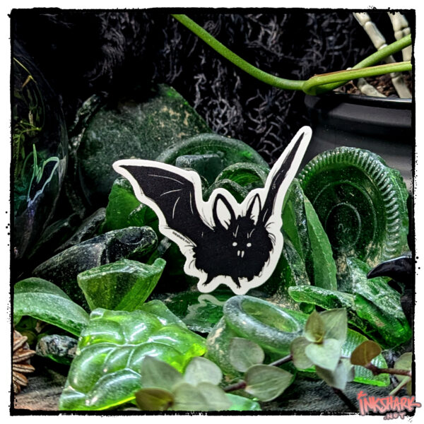 Sticker of a bat perched in a mass of adventurous green sea glass, with live plants guarding it