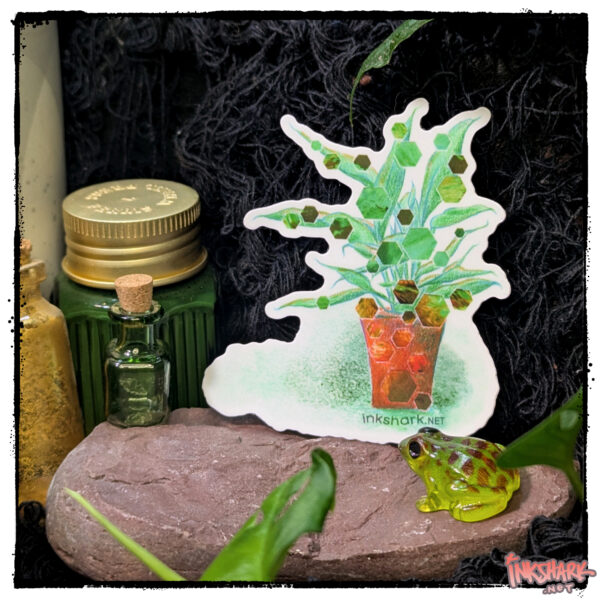 Sticker of a drawn potted plant with hexagons collaged onto the leaves, perched on a red stone near some bottles of ink and a tiny glass frog