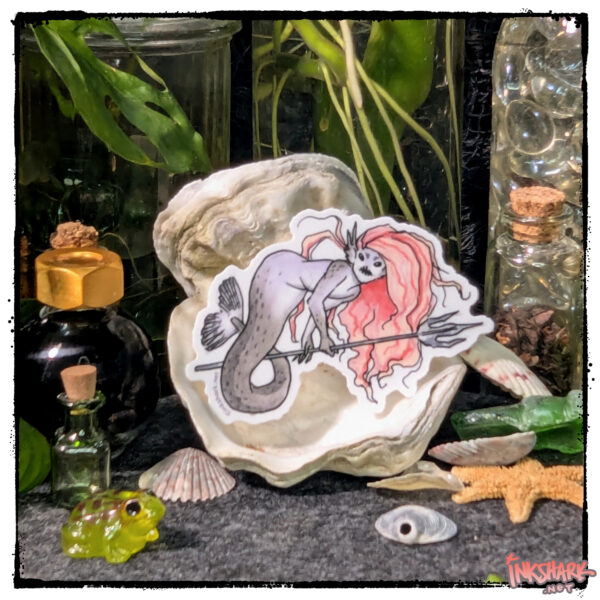 Feisty mermaid sticker posed on an oyster shell, surrounded by fun witchy trinkets and live plants growing in glass jars