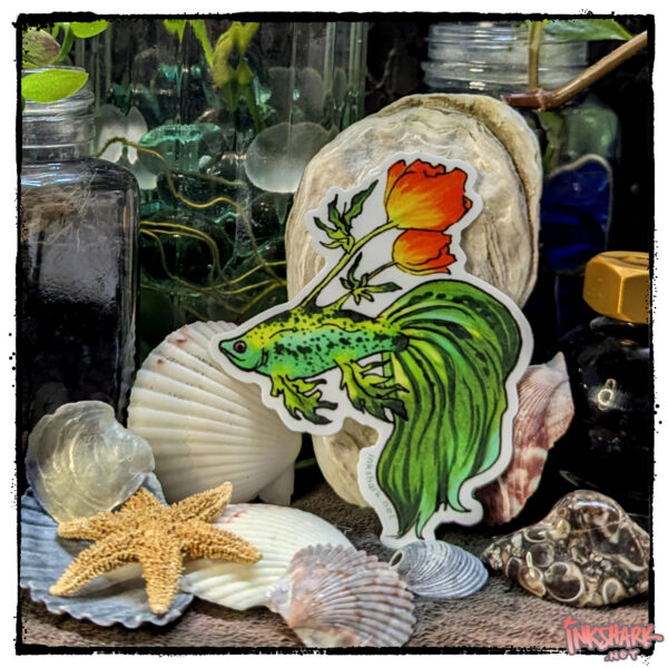 Sticker of a green betta with poppies growing from its back, posed on a backdrop of seashells and witchy jars